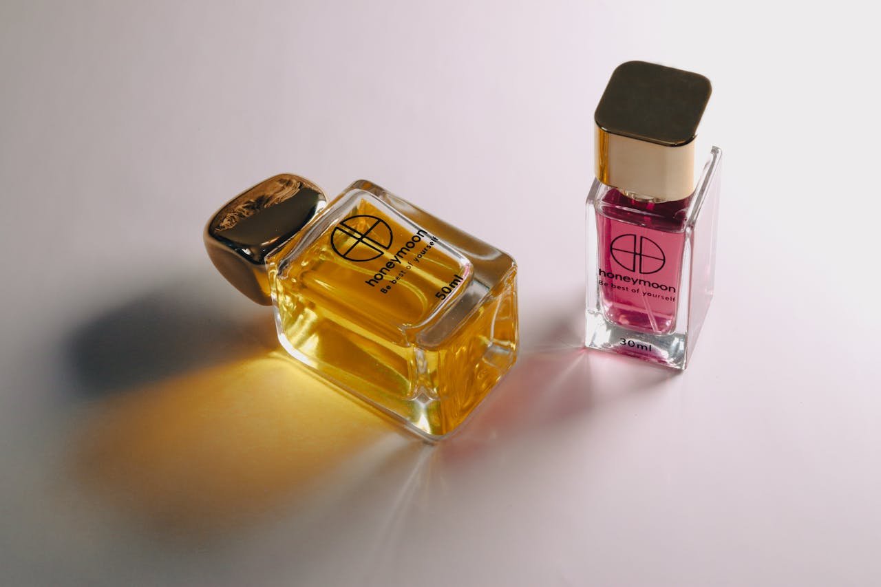 Close-up of elegant glass perfume bottles on a white surface showcasing luxury scents.